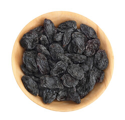 Black raisin iin wooden bowl solated on white background . Top view. Flat lay