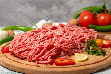 Ground beef. Raw ground beef or minced meat on wood serving board. Close up