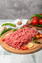 Ground beef. Raw ground beef or minced meat on wood serving board. Close up