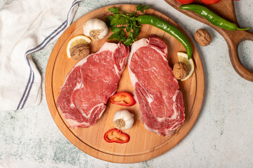 Beef entrecote. Raw beef ribeye on wood serving board. Top view