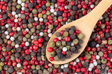 Pepper mix. Heap of black, red, white and allspice peppercorns isolated on white background, close up