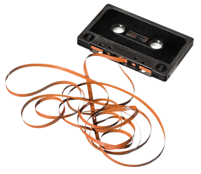 Audio cassette with unrolled tape. Isolated background.