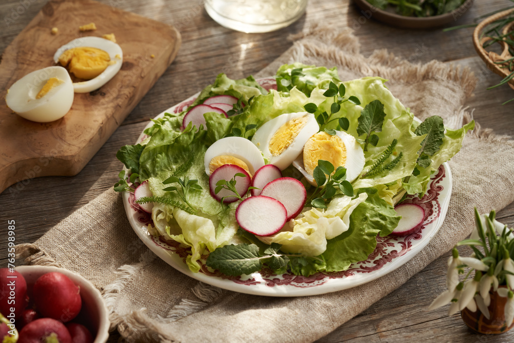 Wall mural Spring vegetable salad with eggs and wild edible plants - chickweed, nipplewort and yarrow