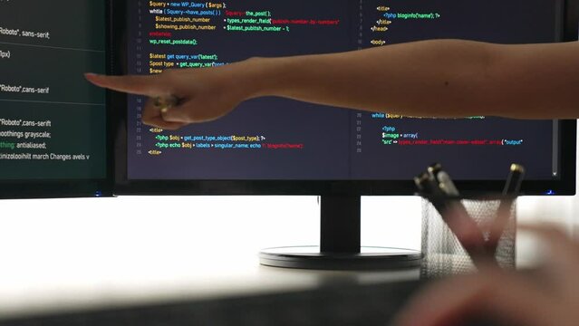 Slow motion closeup hand, back end software developer engineer for computer programming working together on debugging writing computing code, solving complex algorithms display on monitor. Burgeoning