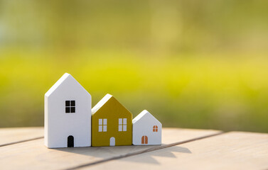 Wooden houses stand in a row outdoors on a sunny day. Real estate and affordable housing concept. Mortgage, loan. Eco-friendly house
