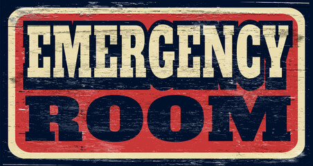 Aged and worn emergency room sign on wood
