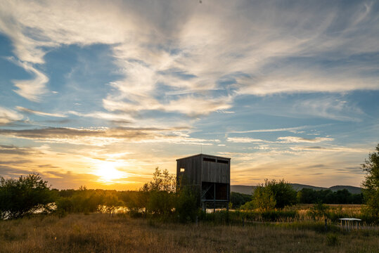 Birdwatching tower in the "Auenlandschaft Hohenrode" nature preserve at dusk, near Rinteln, Weserbergland, Germany