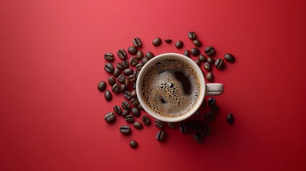 Foto op Plexiglas A cup of coffee with a pile of coffee beans scattered around the cup on a red background.  © Favio