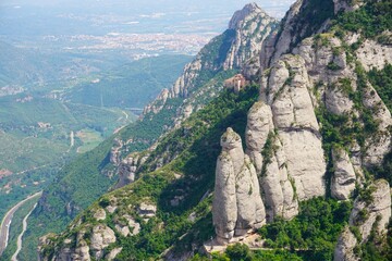 Breathtaking View of Montserrat from Mountain Top. A panoramic view of a mountain valley bathed in the warm light of sunset