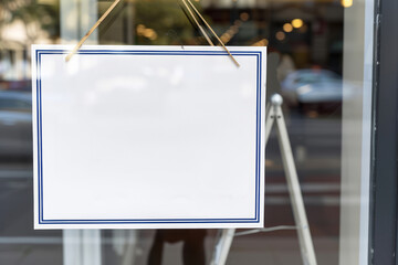 A blank sign in a shop window. Copy space for text