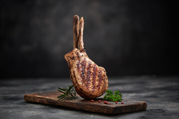 Grilled pork meat with bone on wooden board - 763608125