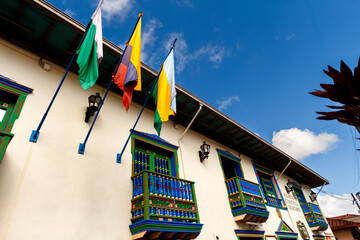 Flags of Antioquia, Colombia and Guatape on the facade of the Municipal Palace of Guatape