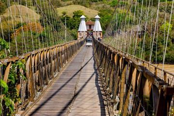 Mototaxi crosses the Western Suspension Bridge in Santa Fe de Antioquia, Colombia 