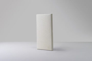 Matte white tall thin chocolate box packaging. Blank cardboard mockup. Textured paper. (real photo) 3D render 