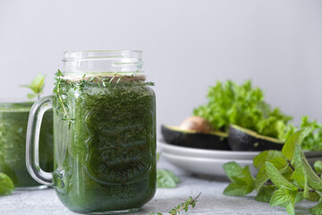 Blended green smoothie with ingredients. Healthy smoothie