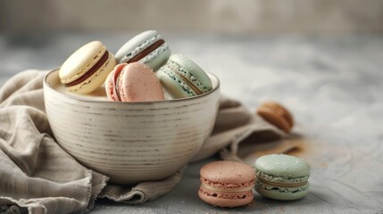 A vertical shot of colorful macarons falling into a bowl of milk against a gray background