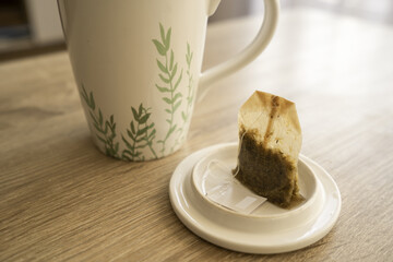 A mug of tea on a wooden table, sun, warm, cold. High quality photo