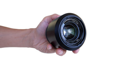 Hand holding camera lens on white background