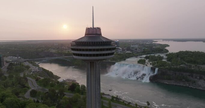 Aerial Panning Shot Of Famous Observation Deck By Niagara Falls Against Clear Sky During Sunset