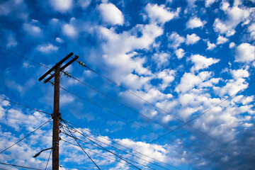 poste de electricidad en cielo azul con nubes