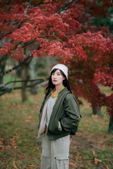 Portrait of a young Asian woman with autumn leaves