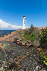 Summer aerial view of Povorotny lighthouse, Vikhrevoi island, Gulf of Finland, Vyborg bay, Leningrad oblast, Russia, sunny day with blue sky, lighthouses of Russia travel