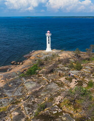 Summer aerial view of Povorotny lighthouse, Vikhrevoi island, Gulf of Finland, Vyborg bay, Leningrad oblast, Russia, sunny day with blue sky, lighthouses of Russia travel