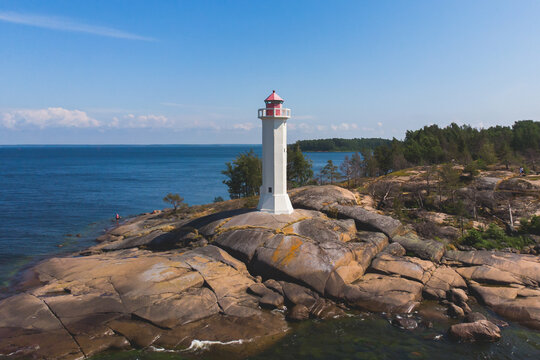 Summer aerial view of Povorotny lighthouse, Vikhrevoi island, Gulf of Finland, Vyborg bay, Leningrad oblast, Russia, sunny day with blue sky, lighthouses of Russia travel