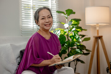 An old woman lived happily in her retirement at home, A kind-hearted elderly woman was happily writing down the events that had happened in her life as it was a memorable and beautiful time.
