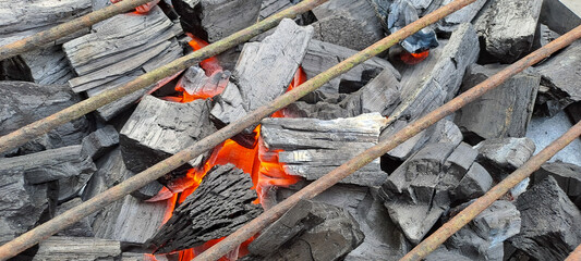 Closeup shot of a pile of charcoal with fire for a barbecue