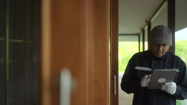 Asian Technician inspector workers in uniform maintenance service with tablet. Profession of service industry house fix repair. Home services concept.
