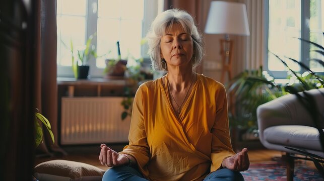 Middle-aged woman meditating peacefully at home, self-care and well-being, stress management, lifestyle photography