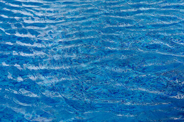 Ripple Water in swimming pool with sun reflection