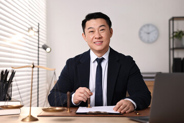 Fototapeta premium Happy notary stamping document at wooden table in office