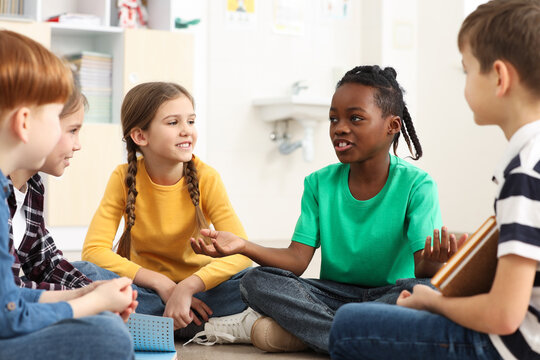 Cute children discussing in classroom at school