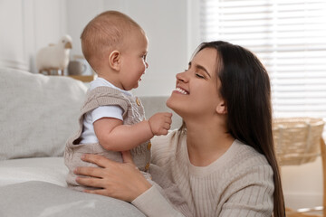 Happy young mother with her baby in living room