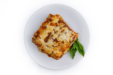slice of lasagna with melted cheese on top and minced meat filling close-up isolated on white background with shadow 2