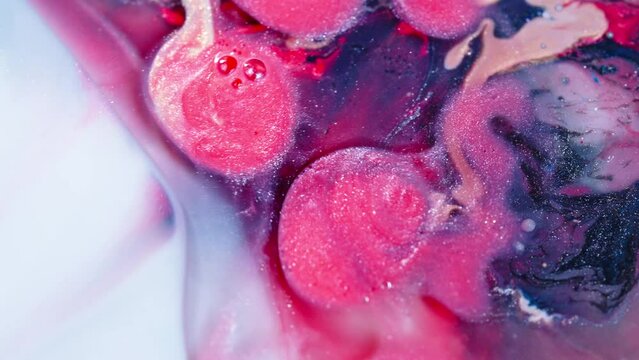 Vivid pink and navy swirls merging in water, creating an abstract art effect, close-up