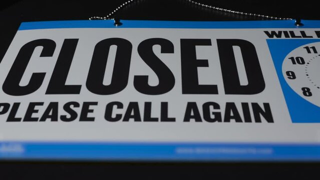 Closed white and blue business sign on dark background 2