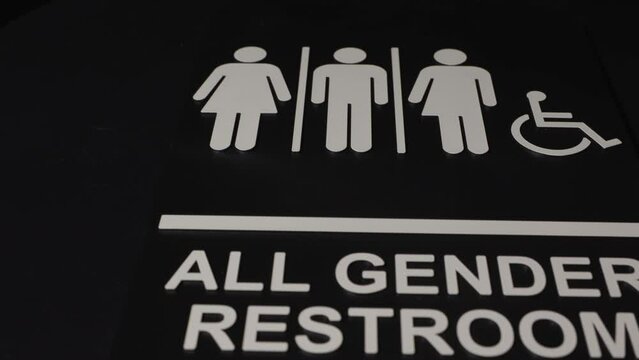All gender restroom sign on dark background