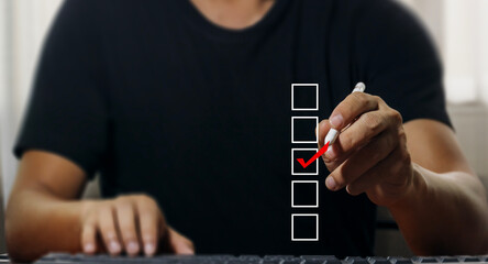 checklist concept Man using pen checks marks in checkbox on virtual screen