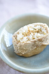 Inarizushi is a traditional sushi using vinegar rice tucked inside a sweet and salty deep-fried tofu envelope.