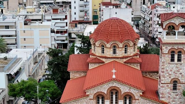 Flying to Greek Orthodox Church, St Emilianos's Church, Skouze Hil in Athens, Greece with dramatic sky 3x zoom.