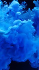 Fototapeta na wymiar Blue paint ink drops in water, Inky cloud swirling flowing underwater. Abstract isolated smoke explosion for background.