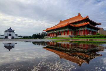 Fototapeta premium The Chiang Kai-shek Memorial Hall and National Theater with their reflections on a shallow pond at the Liberty Square in Taipei, Taiwan. The square is a very popular tour spot for foreigners.