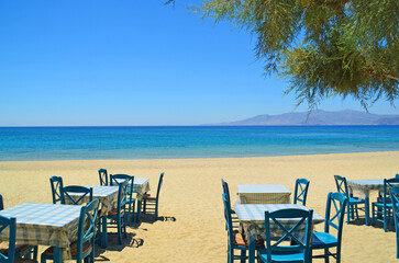 greece naxos sea tables chairs on the beach summer holidays background