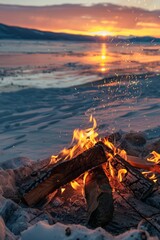 A campfire blazing brightly on a sandy beach, with the sun setting in the background casting a warm orange glow over the scene