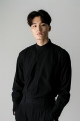 Fototapeta premium A man dressed in a black shirt and black pants standing
