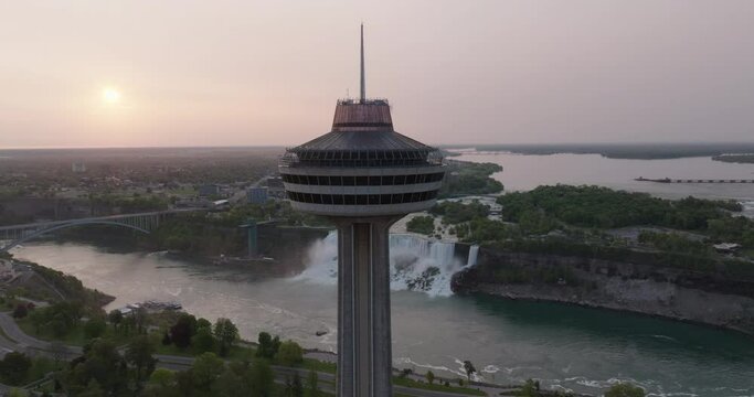 Aerial Panning Shot Of Skylon Observation Deck By Niagara River At Sunset - Niagara Falls, Canada