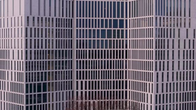 Telephoto aerial riser view of building exterior with lots of windows, abstract